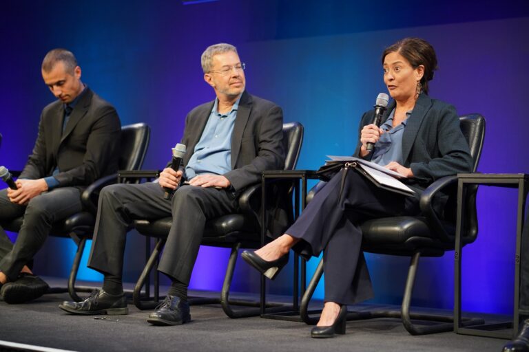 York Space Systems general manager Melanie Preisser speaks into a microphone on the buses and vertical integration panel at Silicon Valley Space Week 2026.
