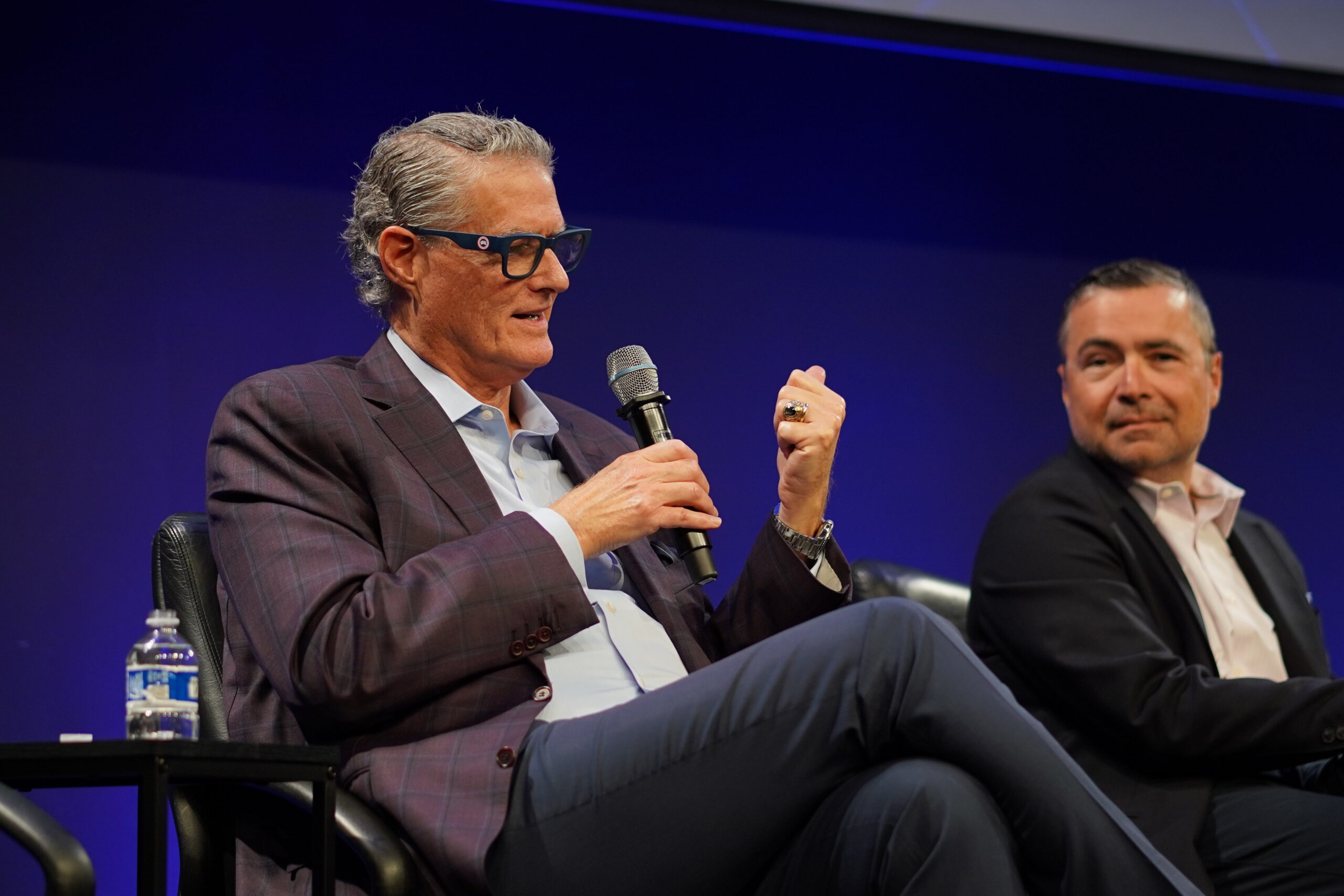 Karl Schmidt of KippsDeSanto speaks on the After SPCX panel at Silicon Valley Space Week 2026 as Matt Oguz looks on