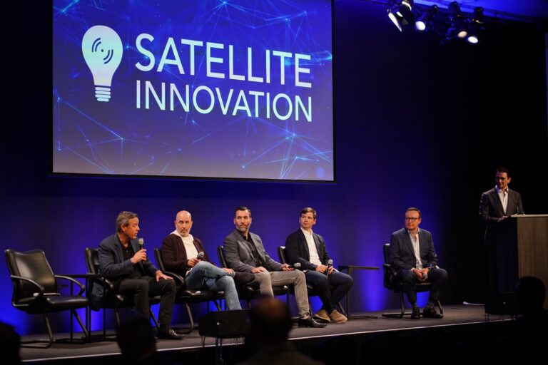 Panelists seated on stage beneath a Satellite Innovation screen during the orbital data centers panel at Silicon Valley Space Week 2026